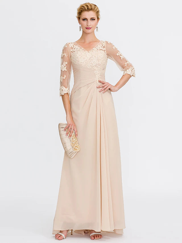 Close-up of the V-neckline and half sleeves with delicate appliques on the chiffon dress.