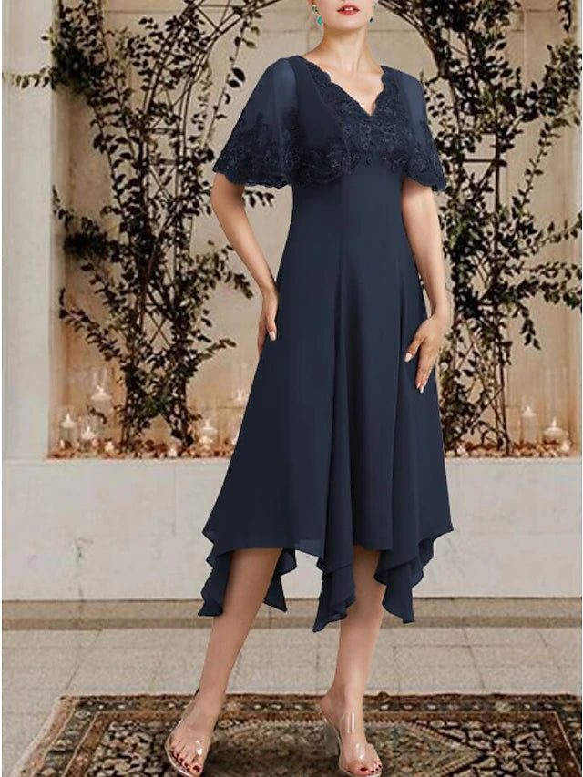 Close-up of the V-neckline and delicate lace appliques on the dress.