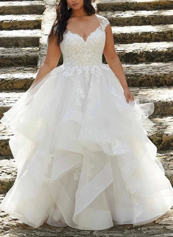 Elegant plus size A-line V-neck wedding dress with lace appliques, front view.