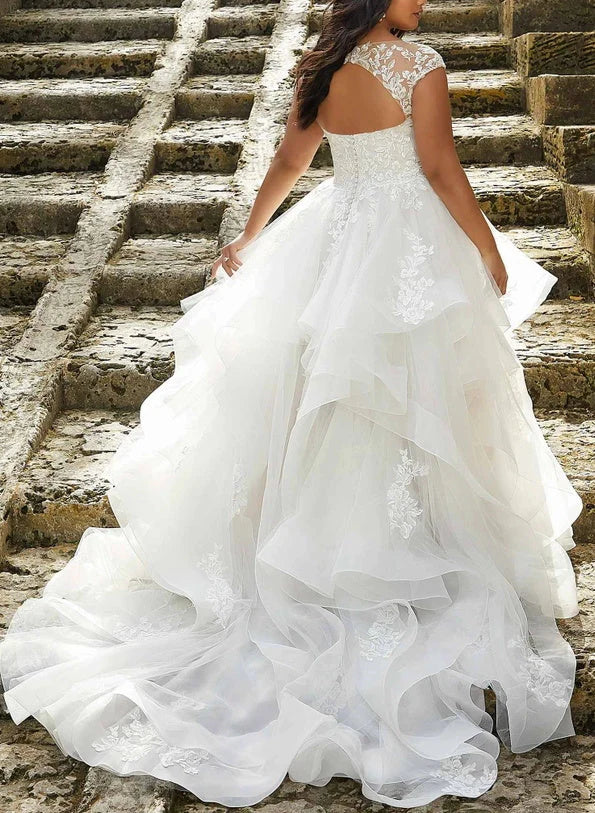 Side view of the plus size A-line V-neck wedding dress with delicate lace details.