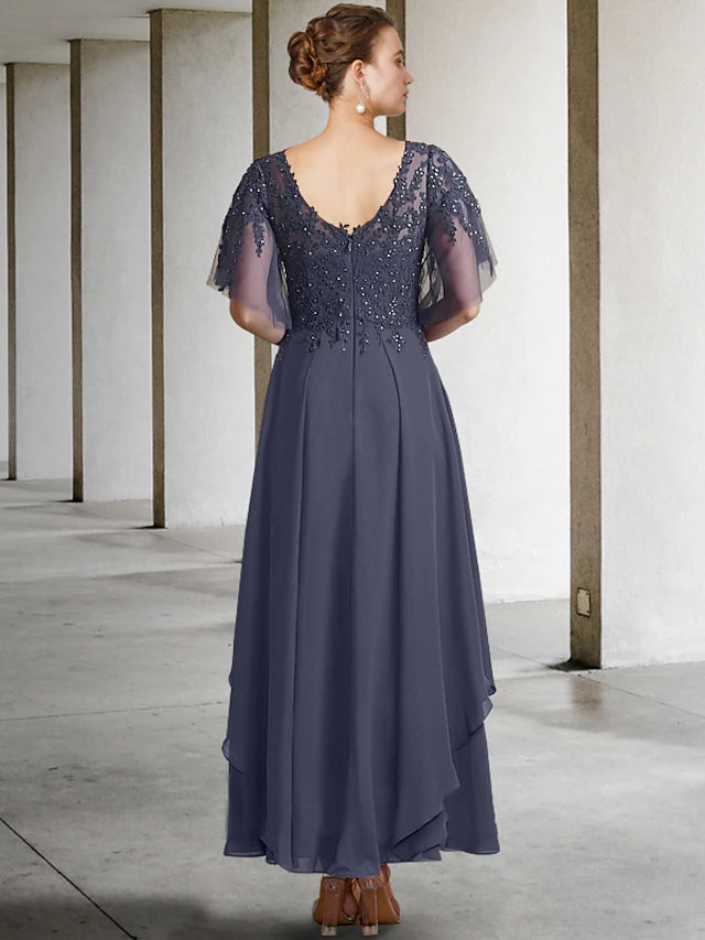 Close-up of the V-neckline and short sleeve detail with lace and beading.
