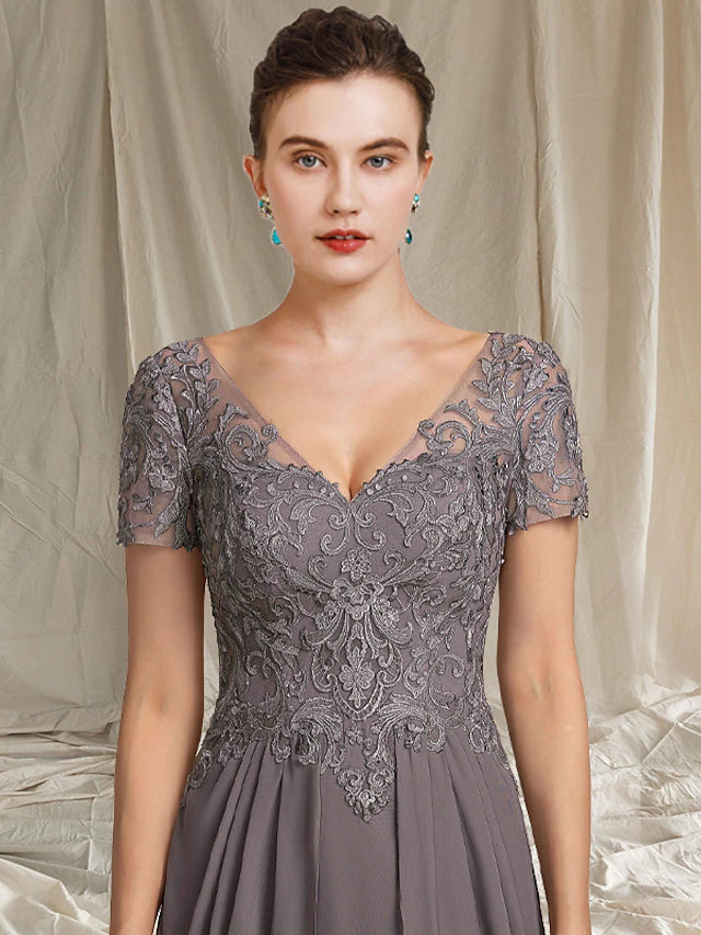 Side view of the chiffon and lace Mother of the Bride dress with high-low hem.