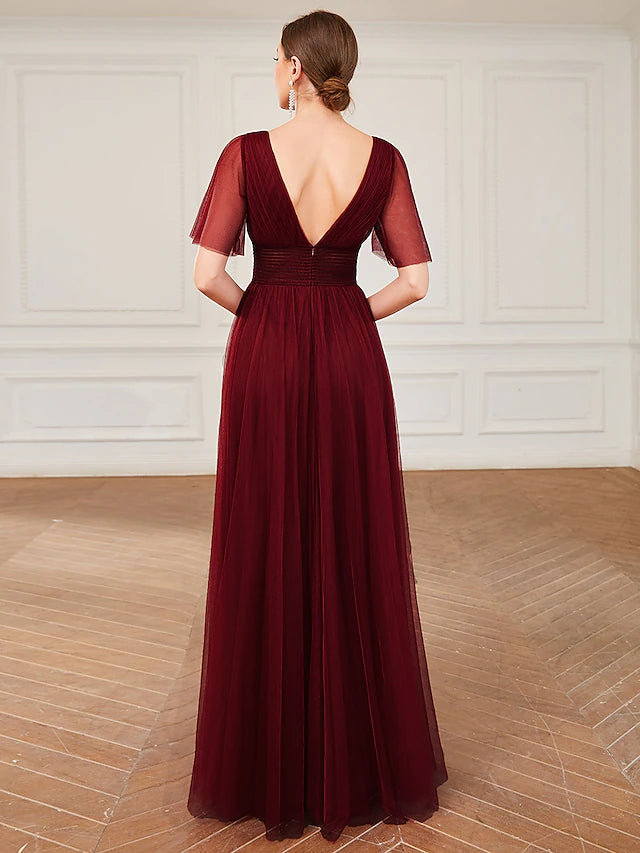 Side profile of a model wearing the plus size A-line bridesmaid gown.