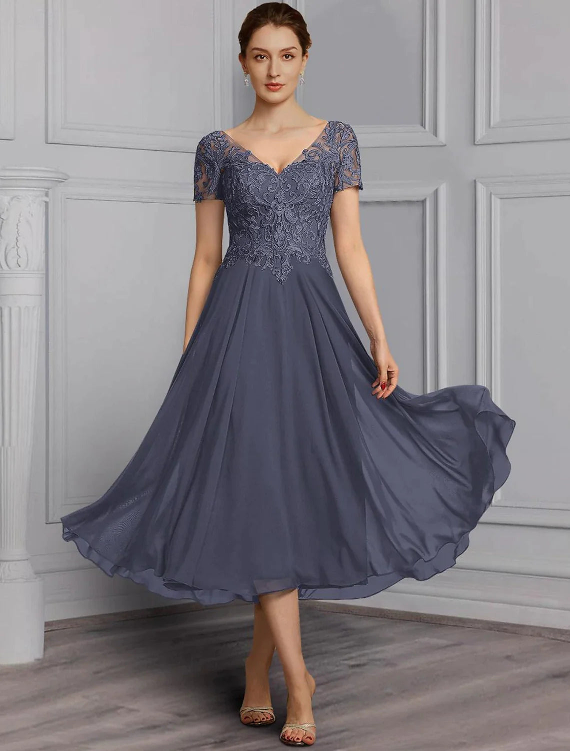 Elegant A-line V-neck tea length dress with short sleeves, chiffon lace, pleats, and appliques.