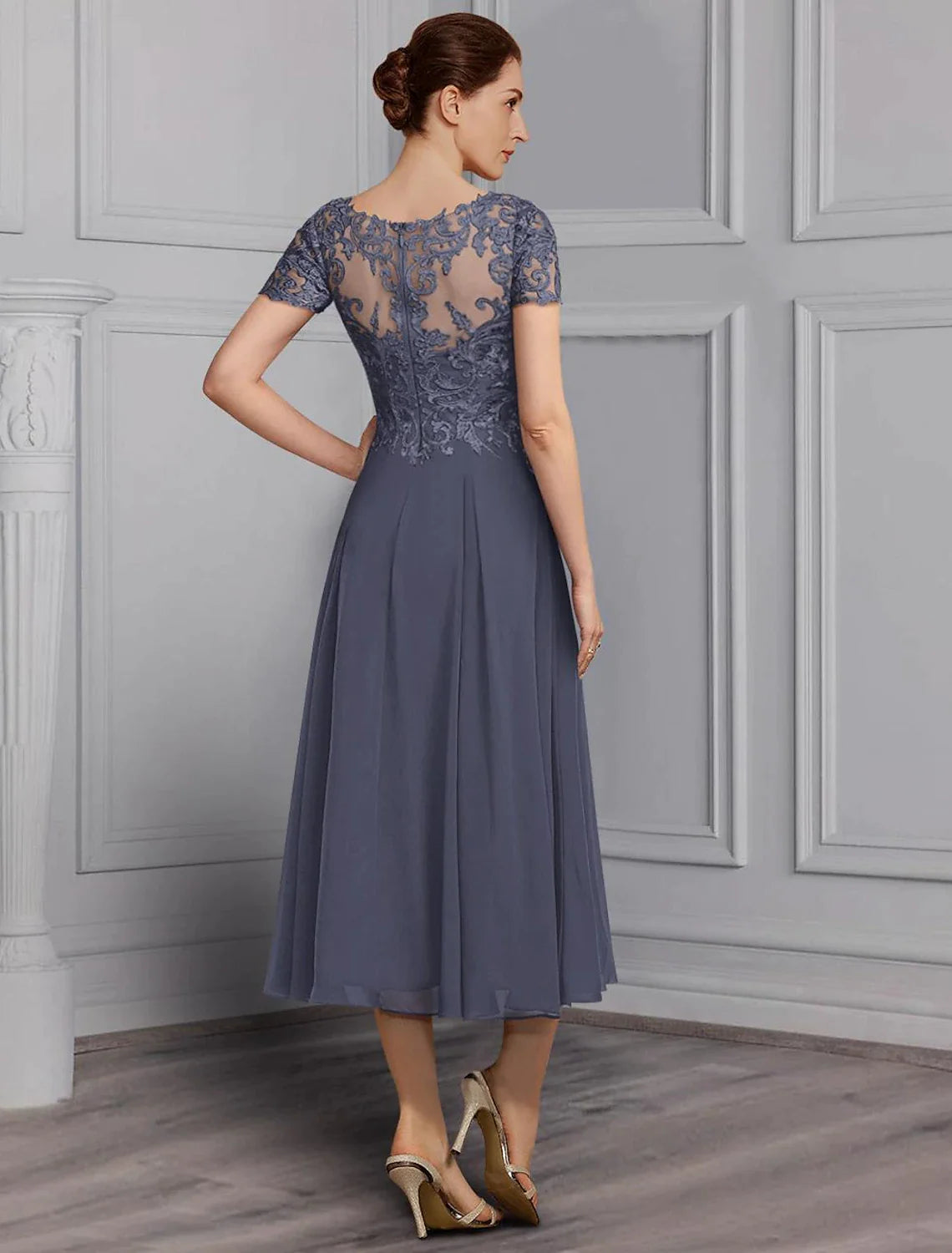 Side view of the elegant A-line V-neck tea length dress with short sleeves and lace details.
