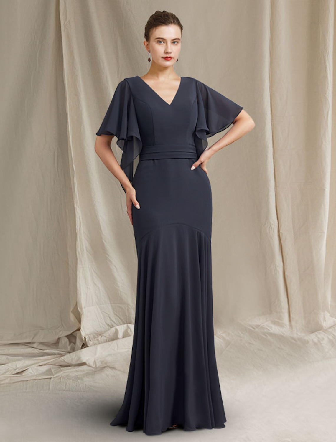 Back view of a floor-length chiffon Mother of the Bride dress featuring ruched details.