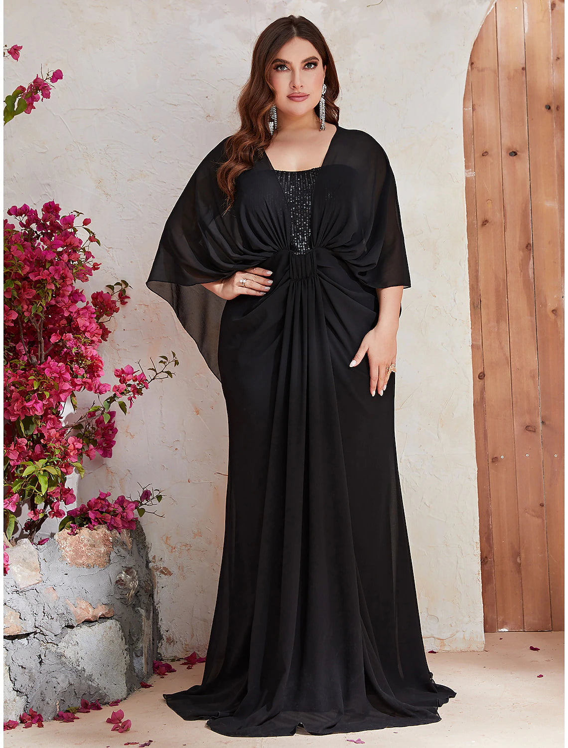 Full length view of plus size trumpet silhouette evening gown.