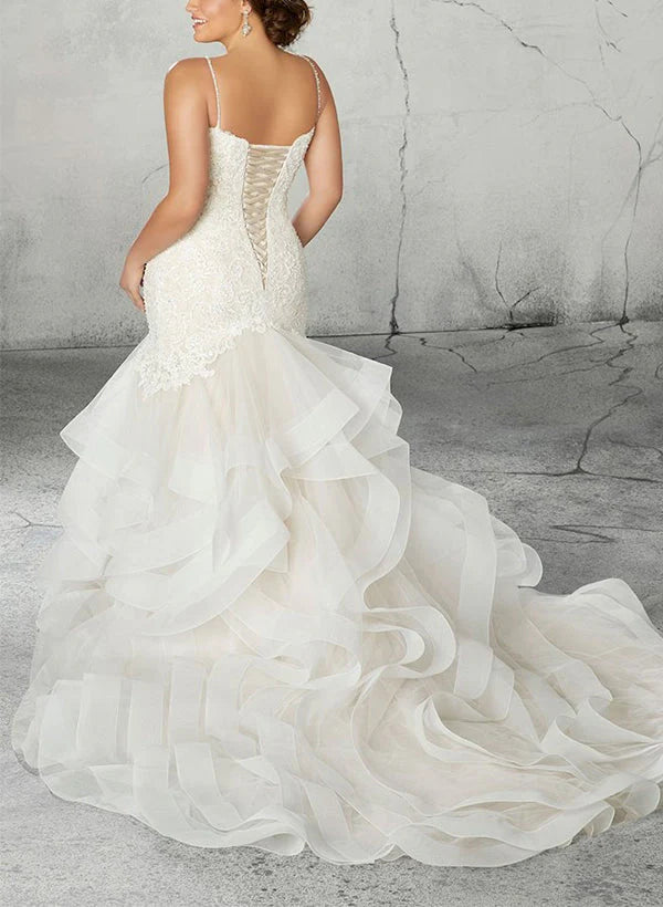 Close-up of the intricate applique lace on a plus size mermaid wedding gown.