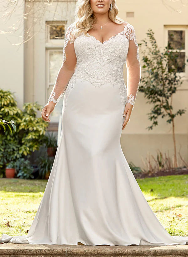 Front view of a model wearing an elegant plus size mermaid wedding dress with a V-neck and long lace sleeves.
