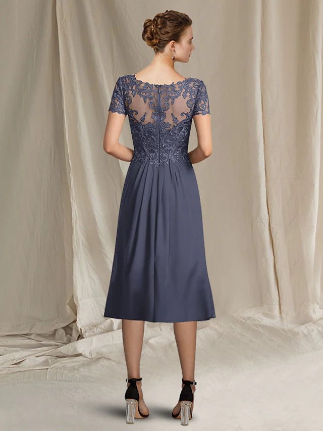 Close-up of the V-neckline and delicate lace appliques on the short sleeve dress.