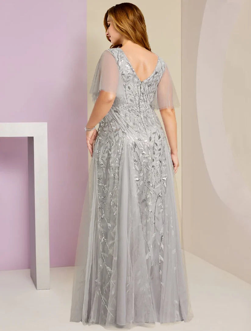 Side view of a plus size woman in a sparkling floor-length V-neck gown, showcasing the lace and sequin details.
