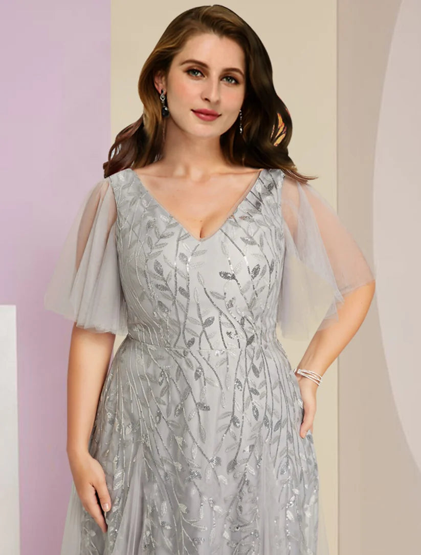 Back view of a plus size woman wearing a formal V-neck Mother of the Bride dress with short sleeves and pleats.