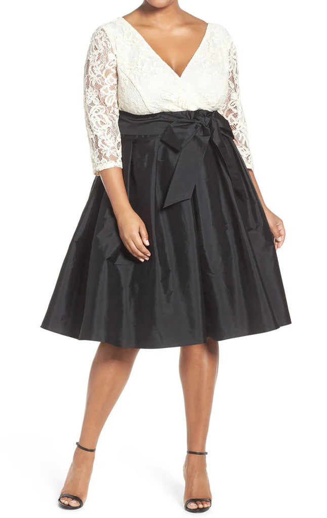 Woman wearing an elegant plus size V-neck A-line dress with half sleeves, suitable for a wedding.