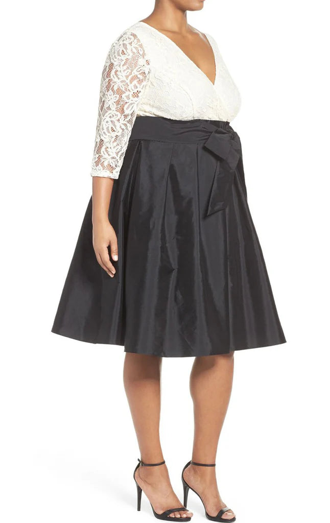 Close-up of the V-neck and half sleeves on a plus size Mother of the Bride dress.