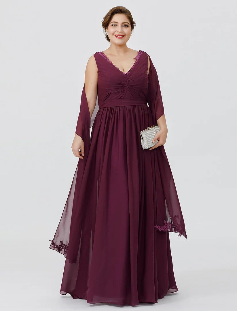 Woman wearing an elegant plus size V-neck chiffon sheath dress with a sash and appliques.
