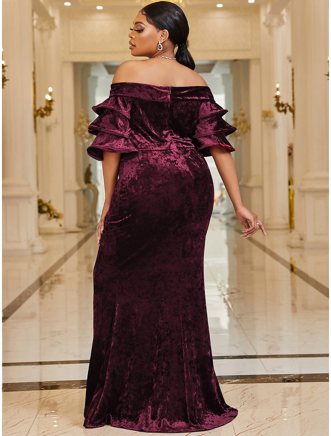 Close-up of the velvet fabric and off-shoulder design on a formal dress.
