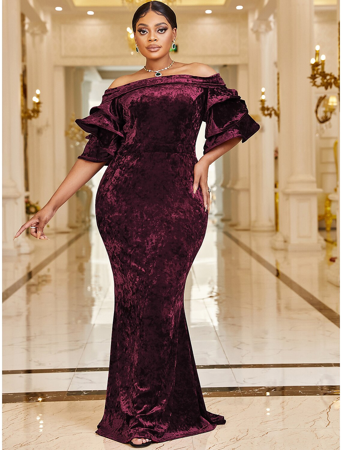Model wearing a plus size velvet mermaid dress, suitable for parties.