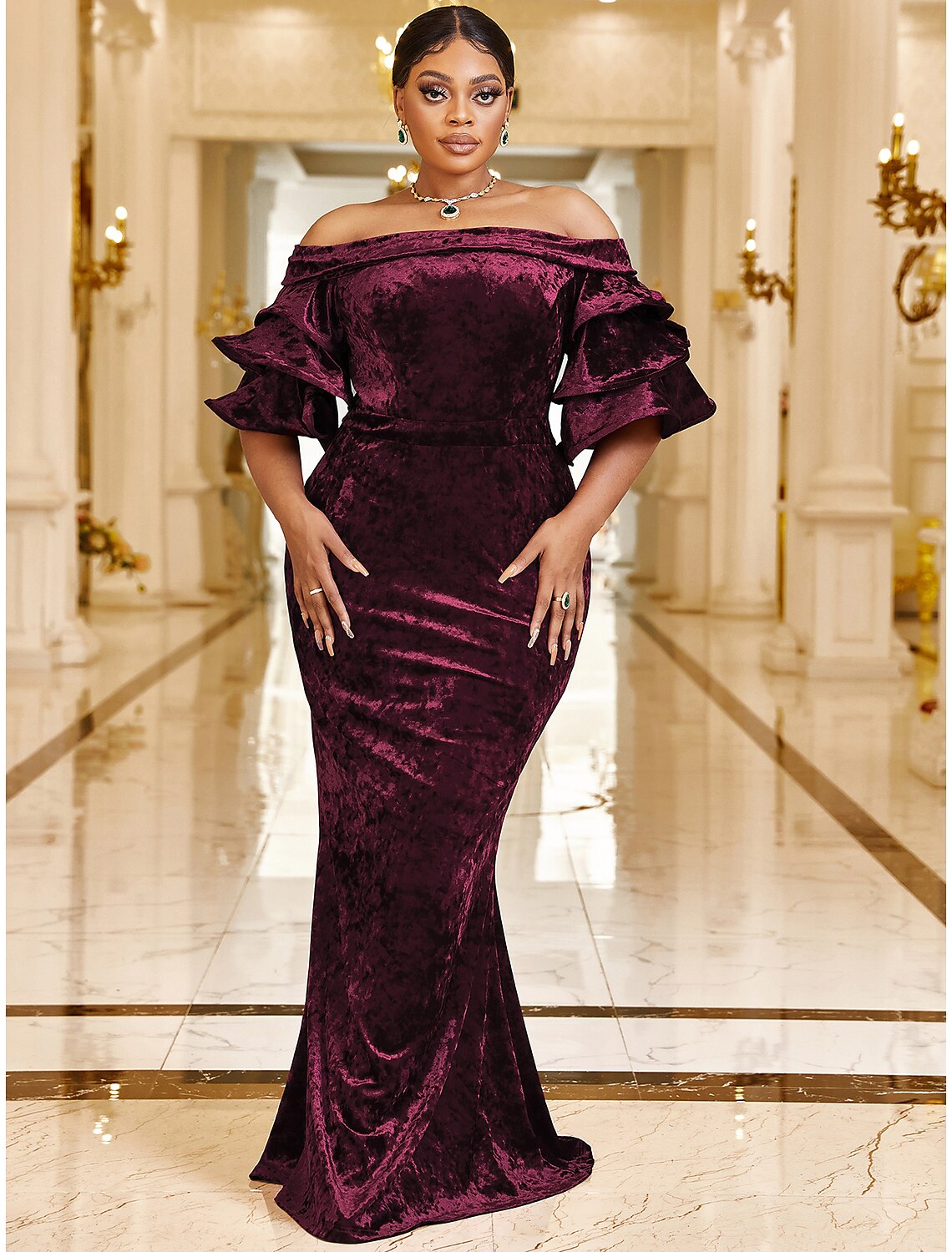 Full length view of a plus size off-shoulder velvet dress with a trumpet silhouette.