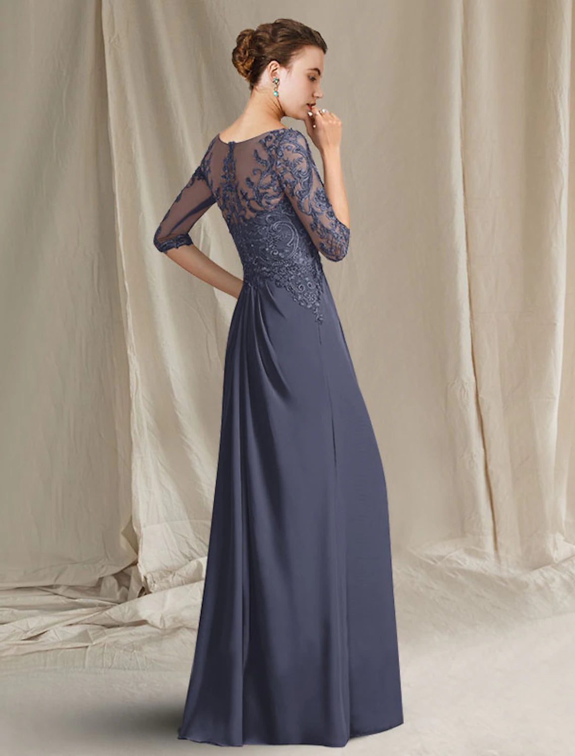 Detail of the pleats, ruffles, and appliques on the elegant dress.