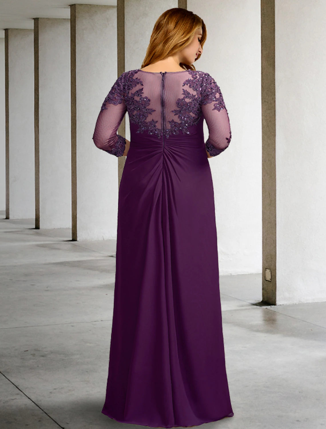 Back view of a floor-length plus size mother of the bride dress in flowing chiffon.