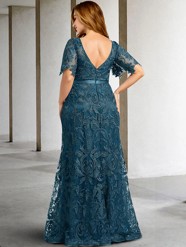 Back view of a plus size Mother of the Bride dress featuring a sweep train.
