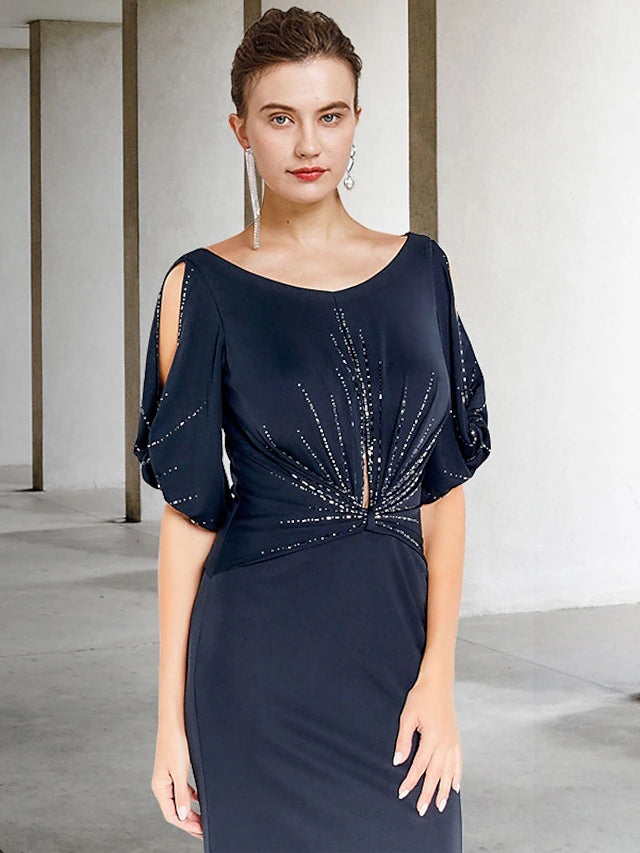 Close-up of the beaded detail on the chiffon fabric of the dress.