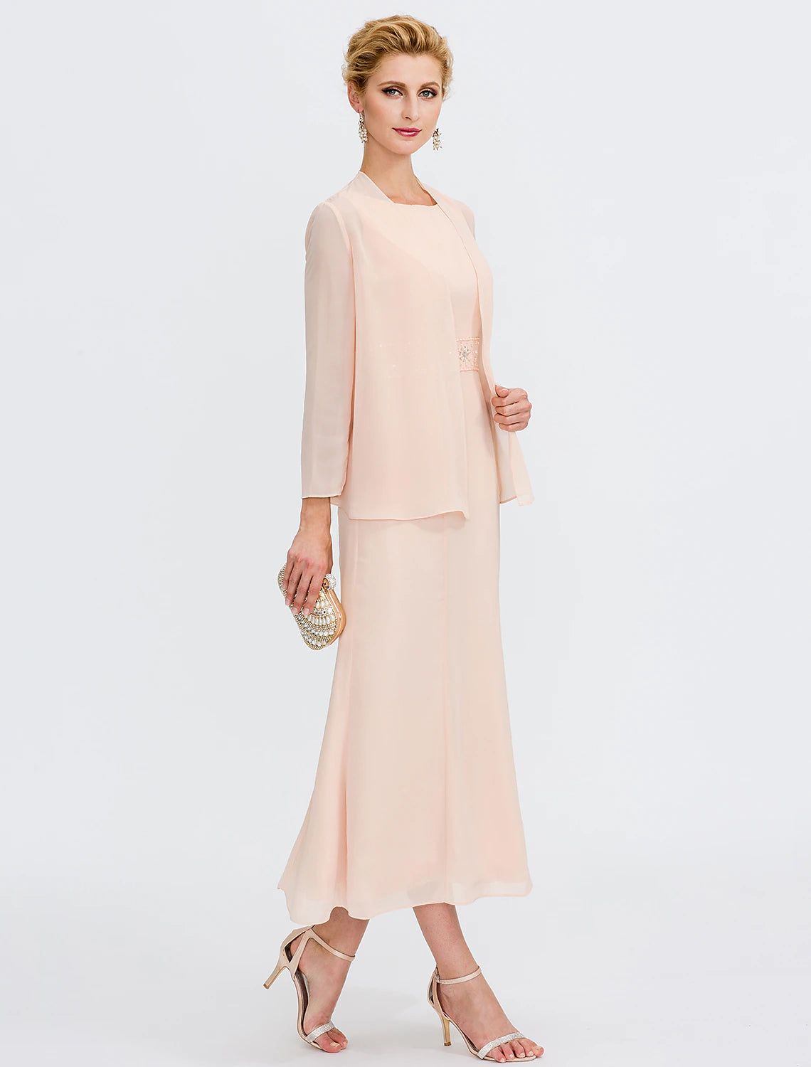 Back view of the tea length sheath dress, highlighting pleats.