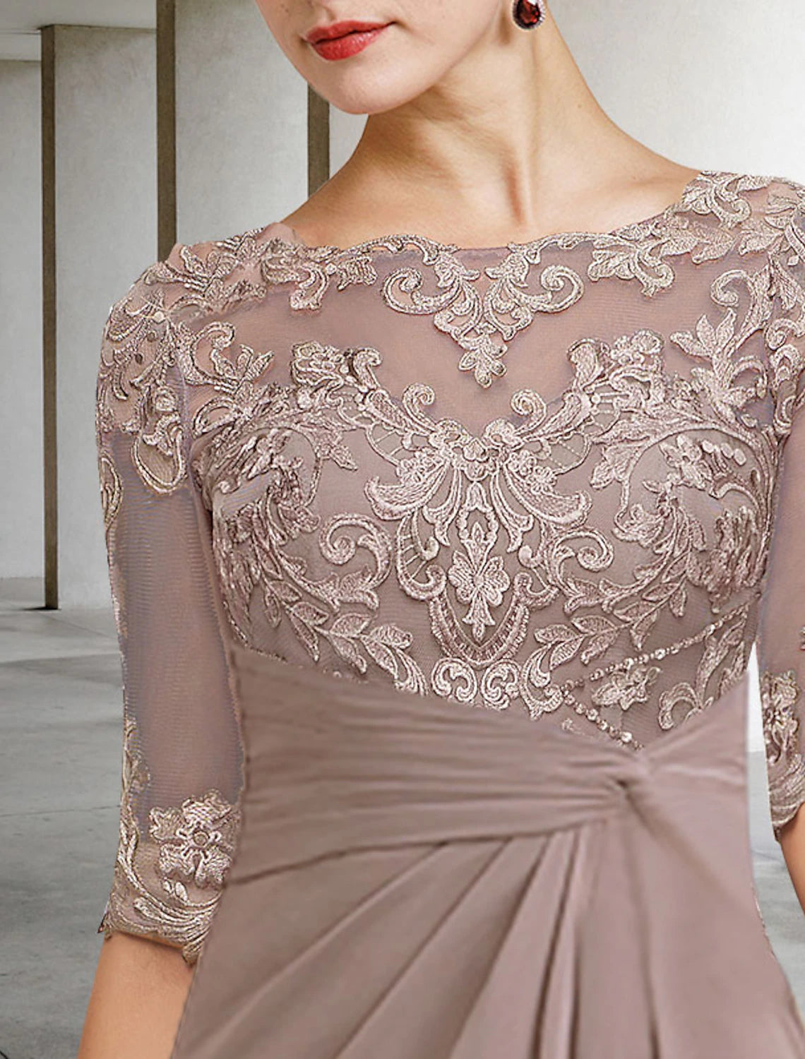 Detail of the lace and applique embellishments on the elegant dress.