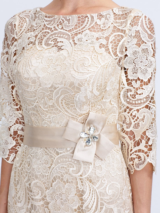Formal knee-length dress with illusion neckline and delicate bow.