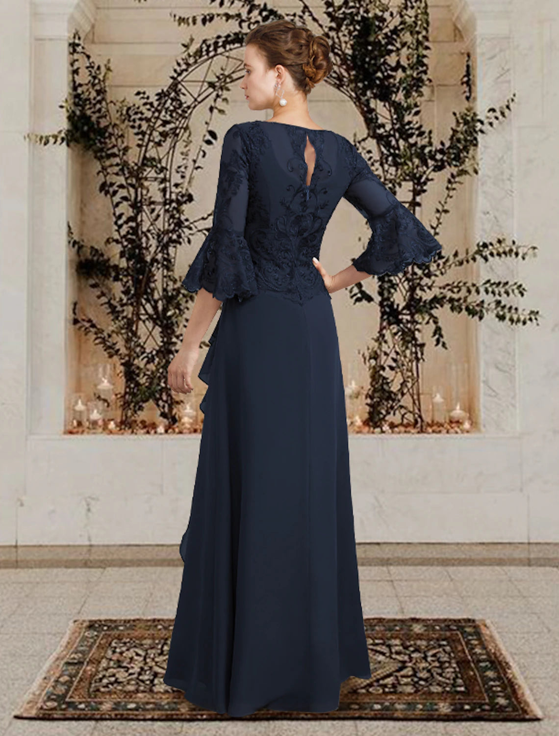 Back view of a floor length chiffon lace Mother of the Bride dress with subtle embellishments.