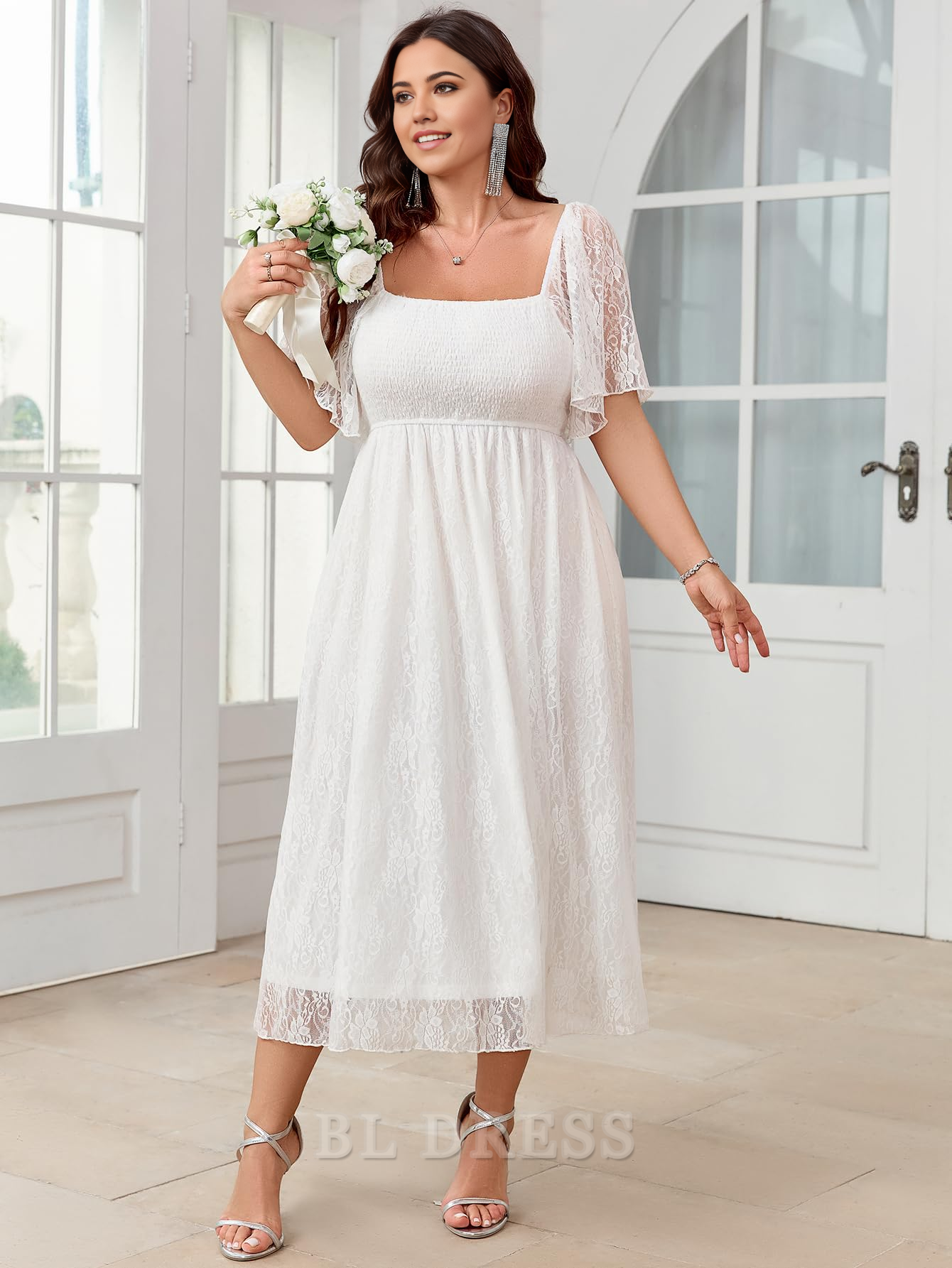 Back view of a plus size square neck lace short sleeve evening gown.