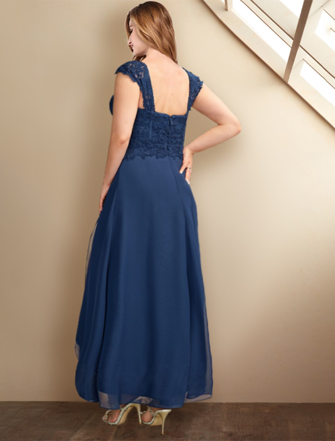 Close-up of the square neckline and half sleeves on the elegant chiffon dress.