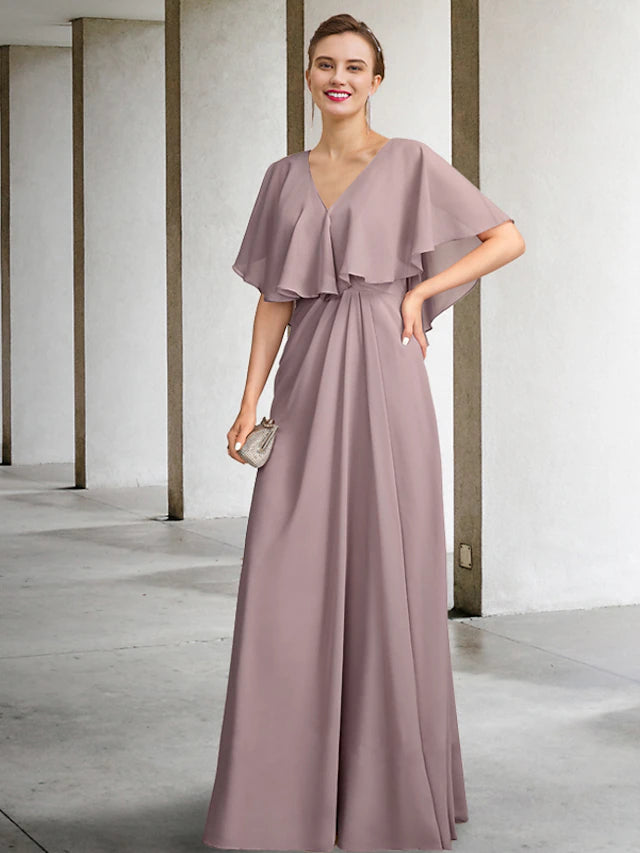 A woman wearing an elegant two-piece V-neck chiffon mother of the bride dress with a matching jacket.