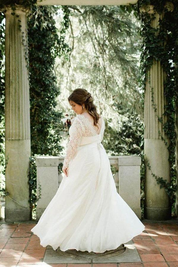Back view of a plus size ivory chiffon wedding dress with long sleeves.