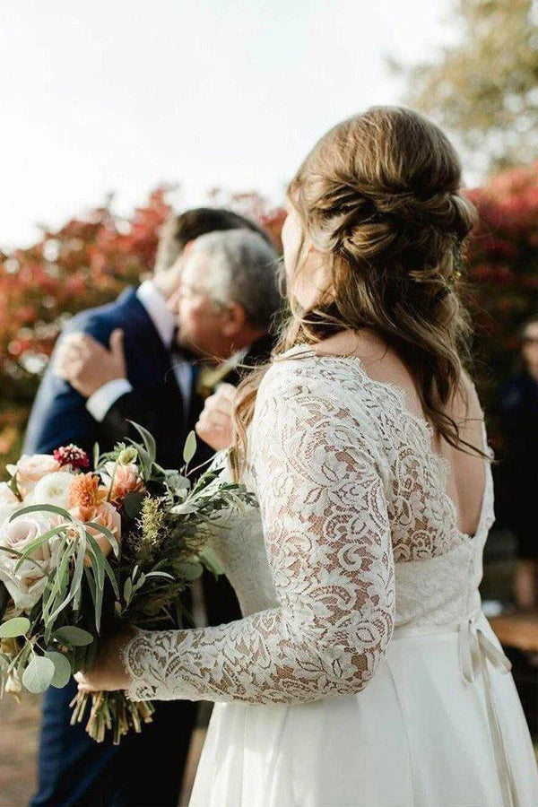 Close-up of the lace top and long sleeves on an ivory plus size wedding gown.