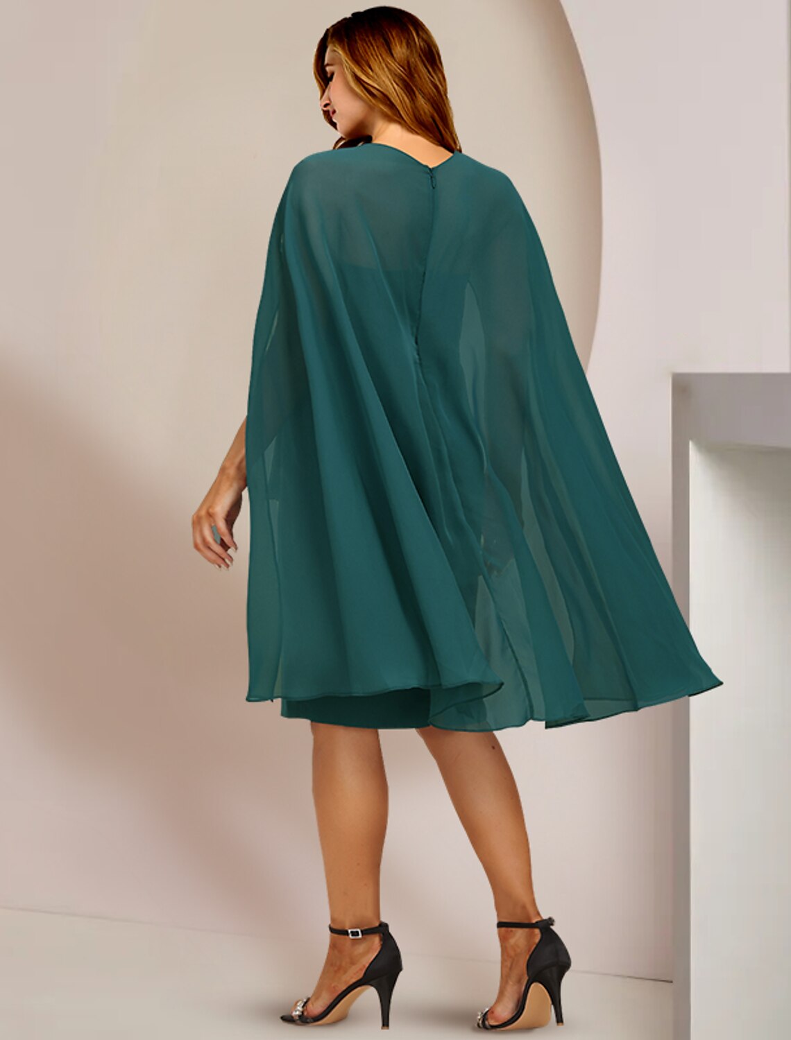 Back view of the plus size Mother of the Bride dress showing pleated details.