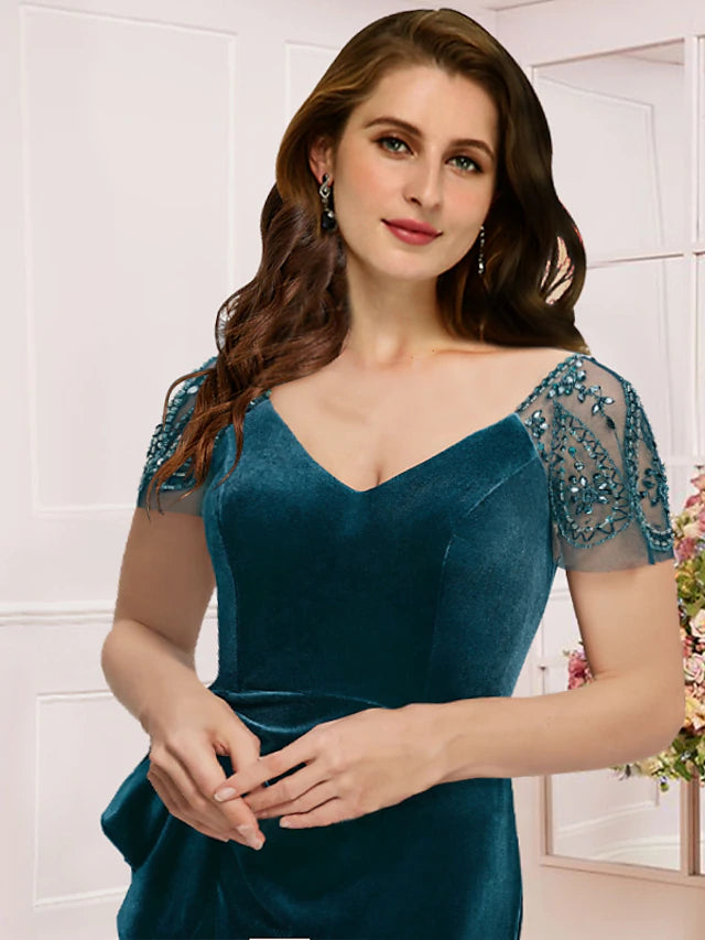 Close-up of the V-neckline and short sleeves on the lace velvet formal dress.