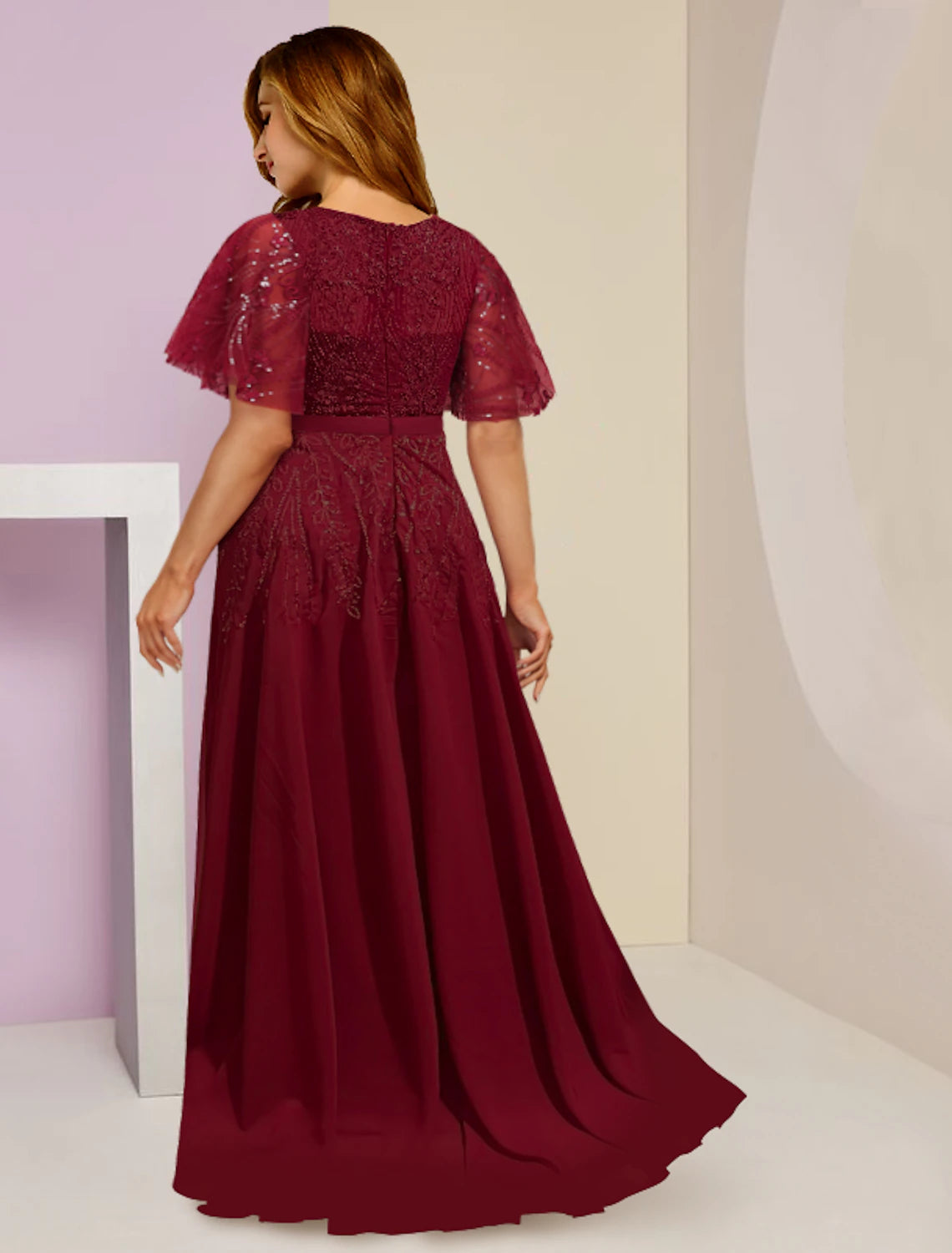 Close-up of sequined and lace details on a floor-length formal dress.