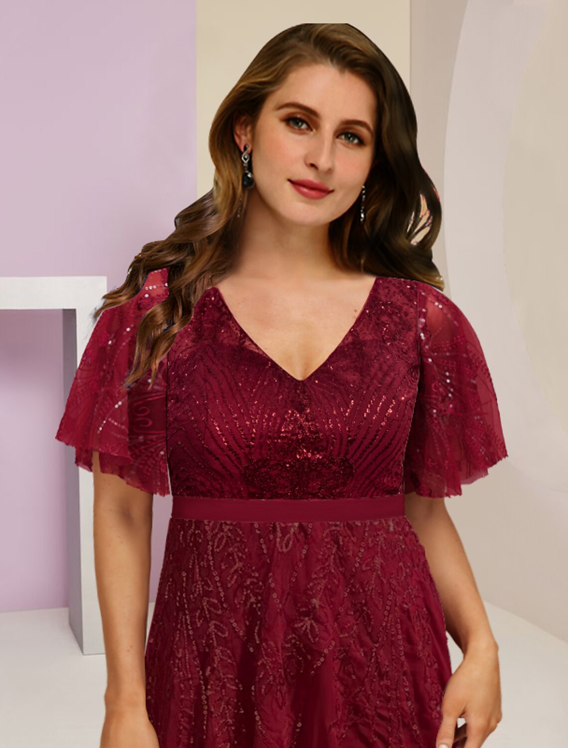 Model wearing a pleated plus size gown with a split front for a wedding.