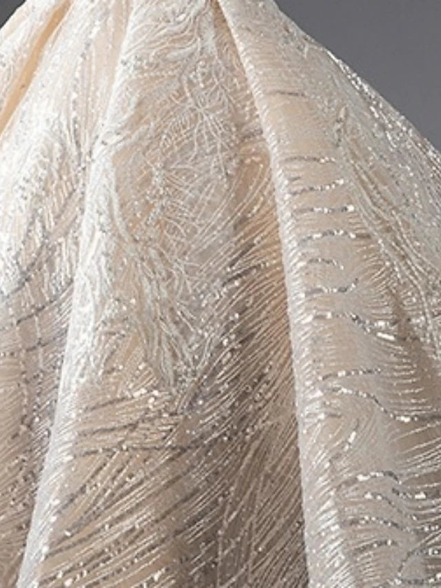 Close-up of faux pearl embellishments on the dress bodice.