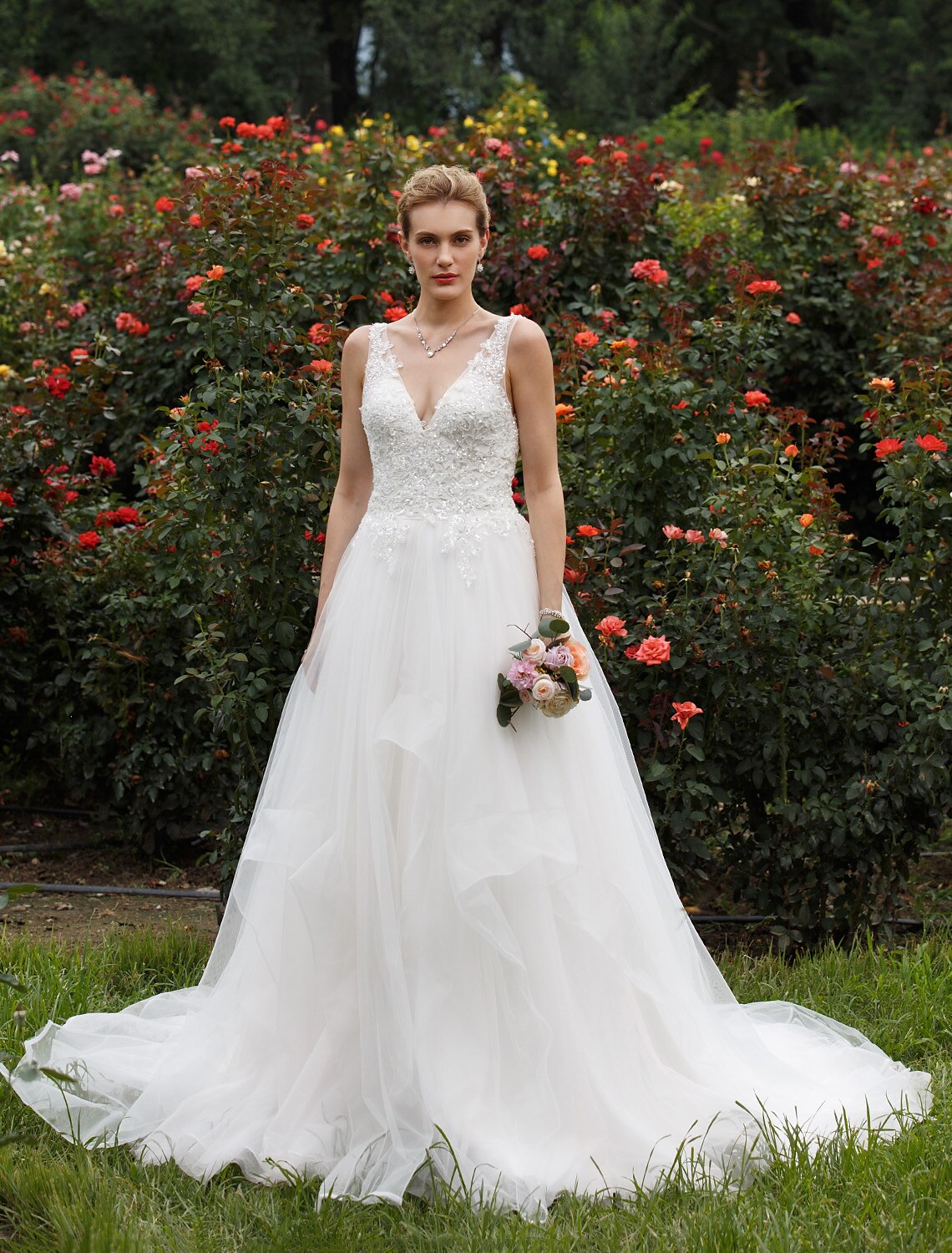 Princess wedding dress with plunging neckline and tulle skirt.