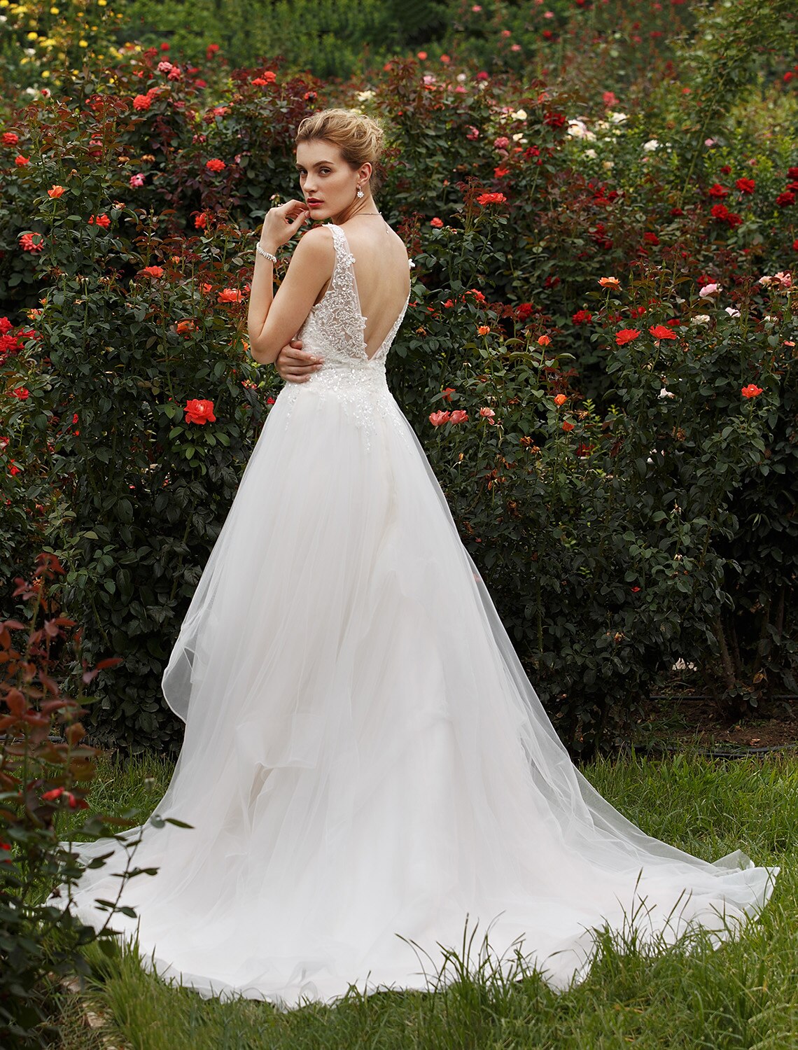 Sleeveless bridal gown featuring sequin embellishments.