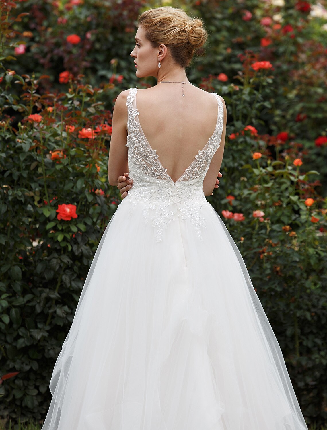 Side profile of a bride in a tulle gown.