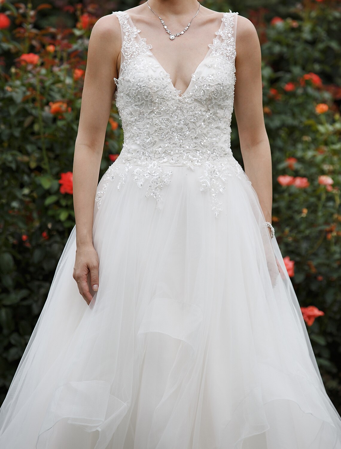 Close-up of the plunging neckline and sequin details.