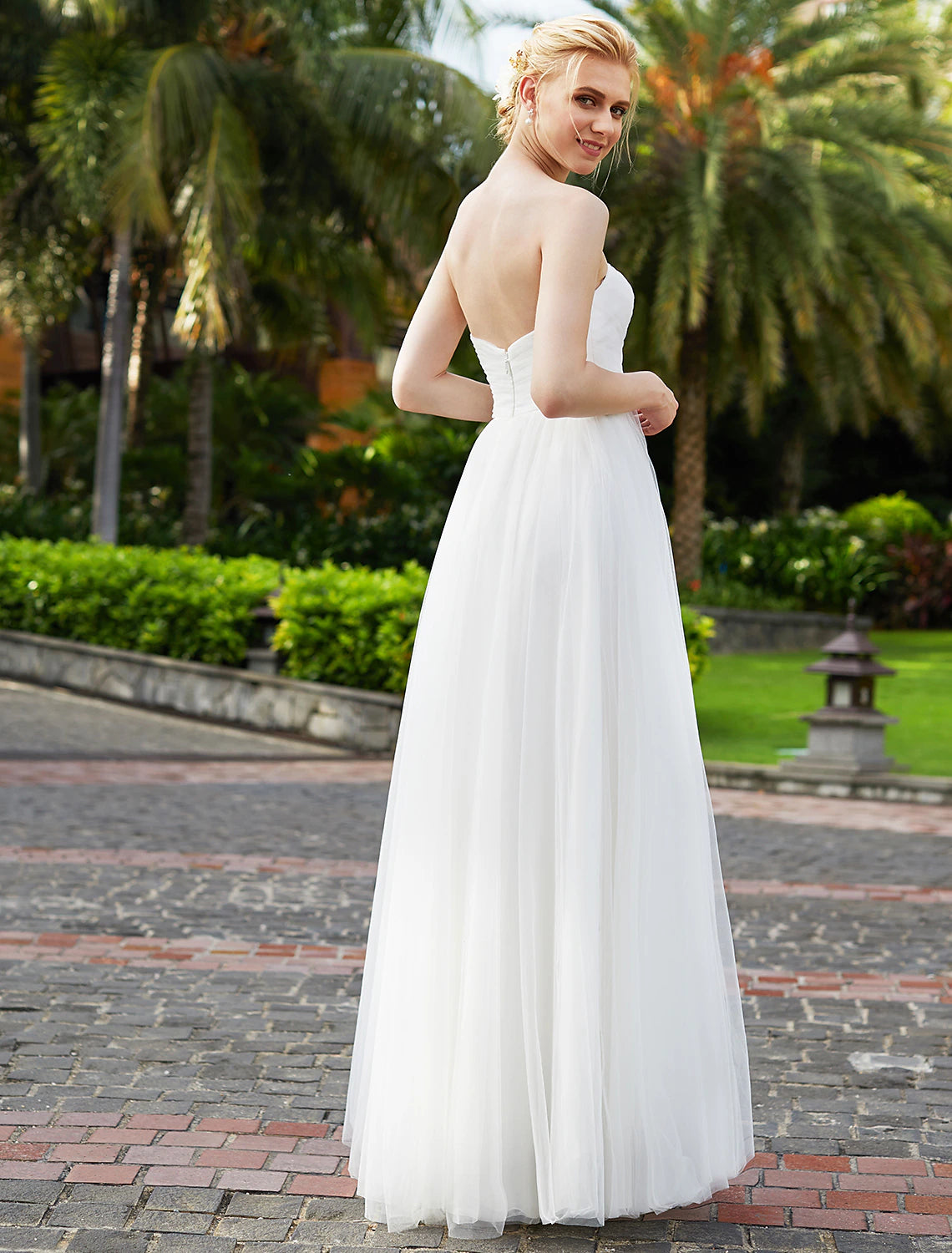 Chiffon bridal gown with flowing skirt and sashes.