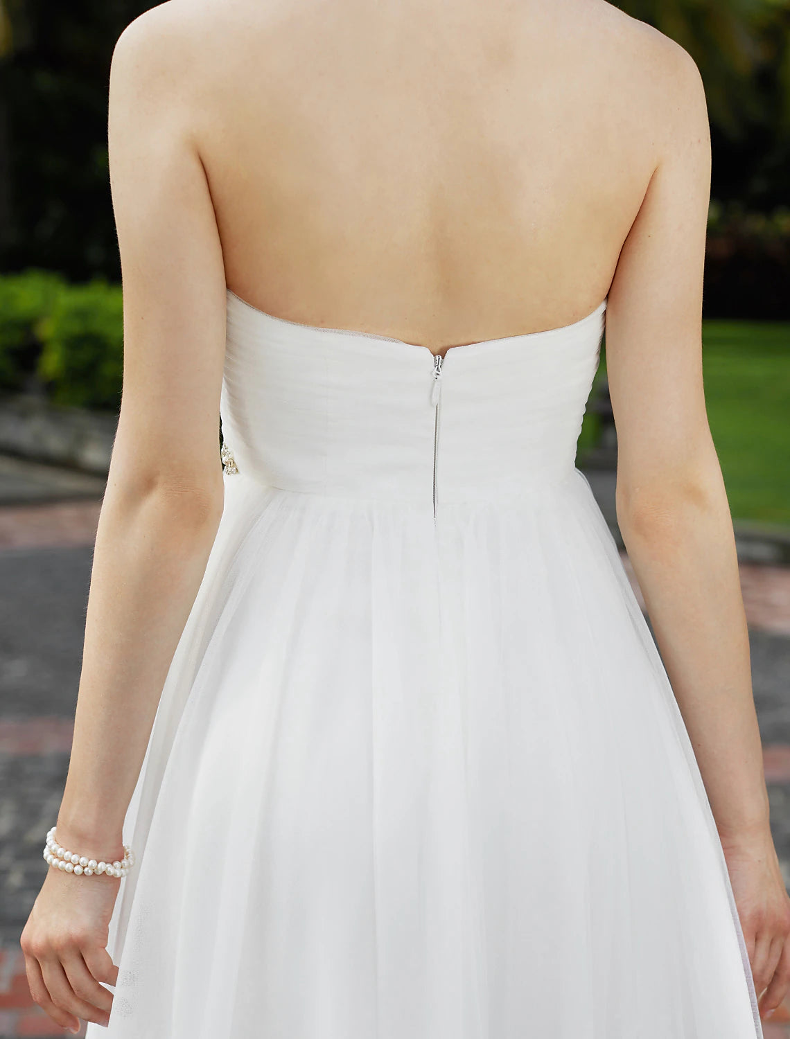 Back view of a princess wedding dress with ribbon details.