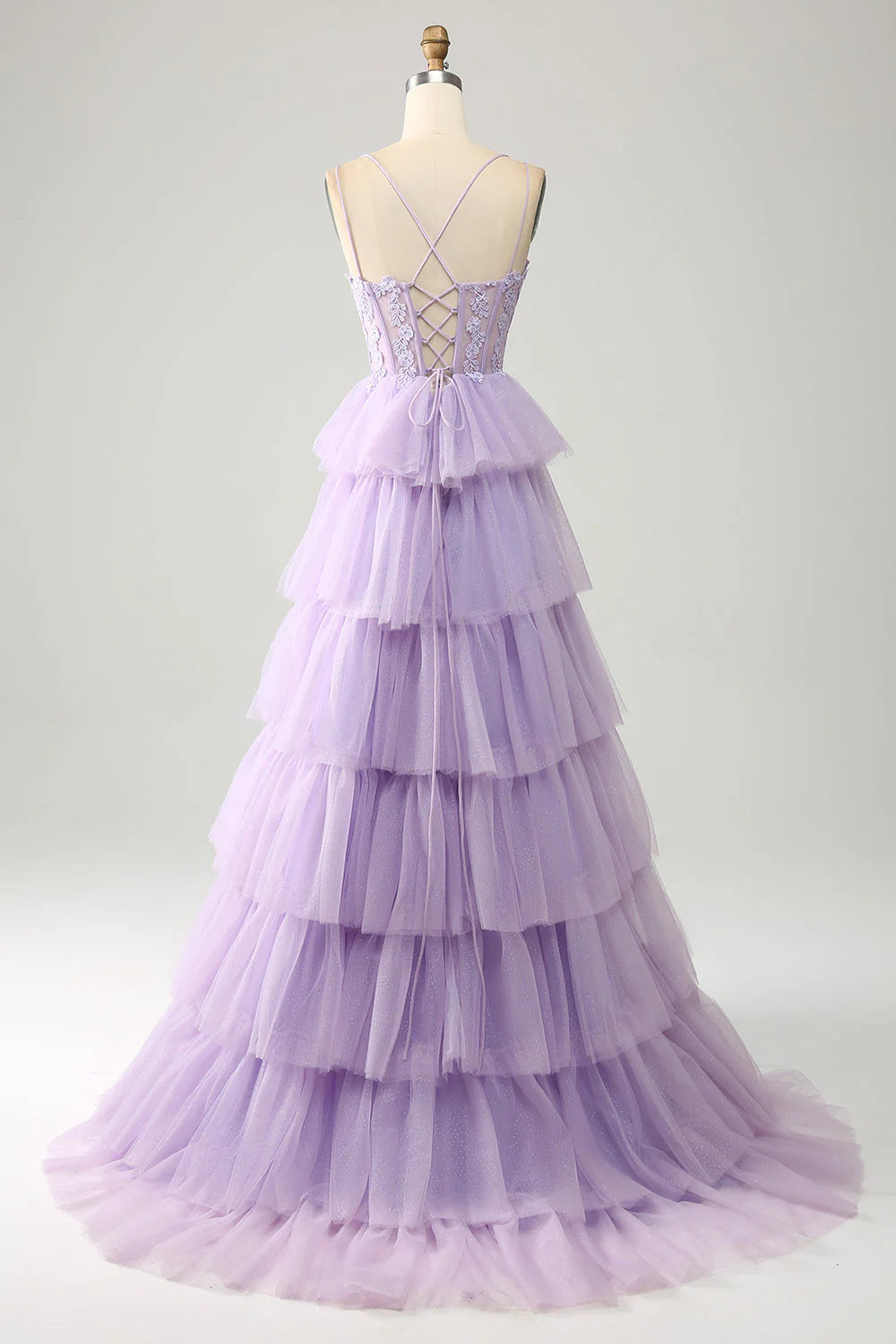 Close-up of the tiered tulle skirt and delicate appliques on the lilac princess prom dress.