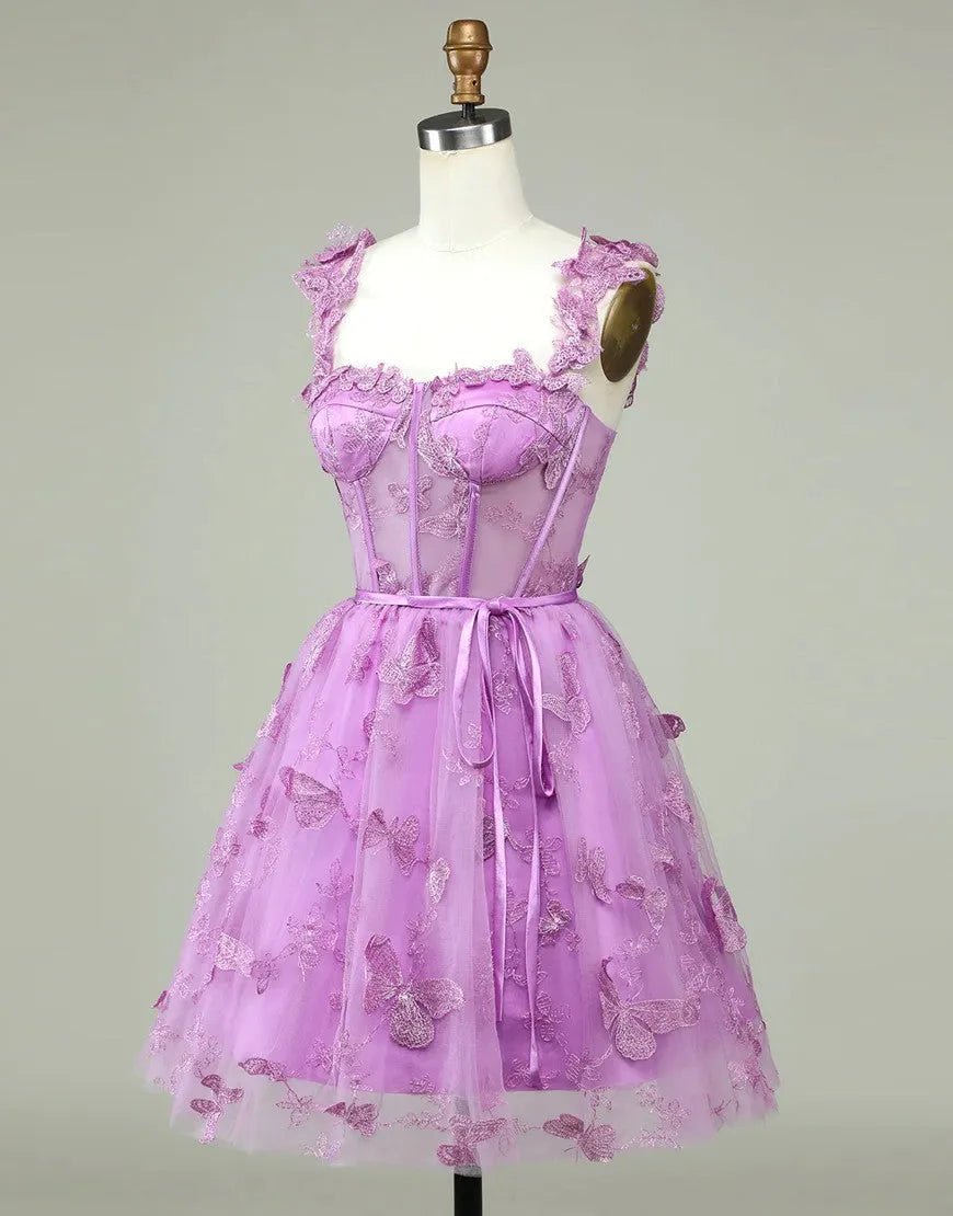 Close-up of appliques on a purple A-line homecoming dress.