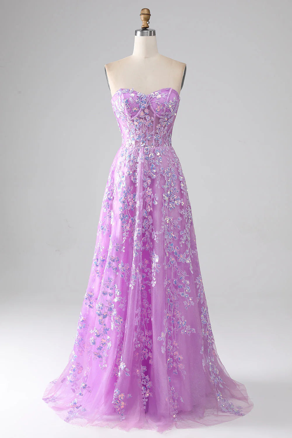 Purple A-line strapless corset prom dress with appliques on a model.