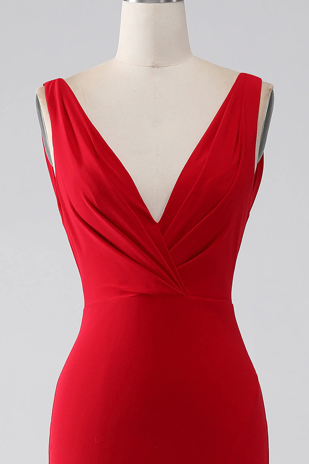 Close-up of the red mermaid V-neck prom dress with slit detail.